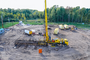 Special equipment for drilling an oil well in an oil field. Workover rig working on a previously drilled well trying to restore production through repairIn a row are oil-producing wells