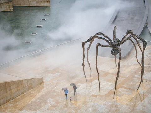BILBAO, SPAIN-FEBRUARY 11, 2018: Maman -- a 9 meters hight sculpture of a spider by Louise Bourgeois that rests in front of the Guggenheim Museum