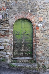 Fototapeta na wymiar Green Old Door in Italy