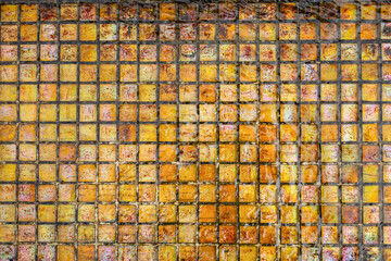 Abstract orange, yellow, brown tile mosaic in water. Top view. Tile texture. 