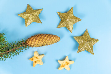 Christmas cookies in the form of stars and New Year's toys stars on a blue background.