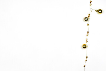 Golden Christmas decorations on white background with copy space