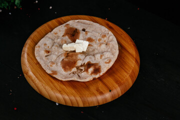 indian tortilla with butter on black background