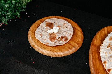 indian tortilla with butter on black background