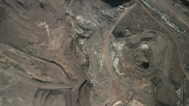 Flight over a mining quarry with equipment for coal mining. Working bucket wheel excavator. 