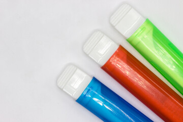 Colourful travel toothbrushes in cases on a white background