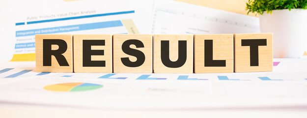 RESULT the word on wooden cubes. Background is a business diagram. Business and finance concept