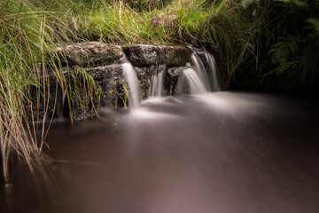 Close up of a large waterfall with trickling white water. Forest of Bowland, Ribble Valley,...