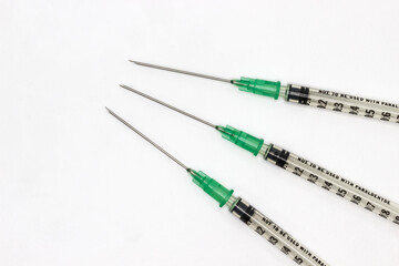 Hypodermic needles on a white background. Shringes for vaccination during the coronavirus pandemic