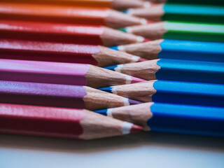Color pencils on white background. Close up. School concept. Warm and cold colors