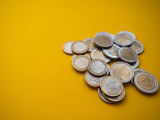 European coins with copy space. Yellow background. Economy concept