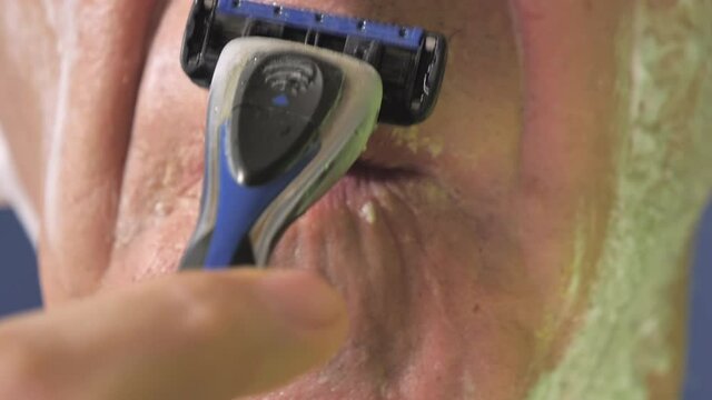 Closer look of the razor blade shaving the small mustache. Vantaa.Finland-October 9.2020
