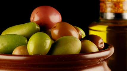 Lot of different olives in pot.