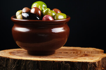 Lot of different olives in pot.
