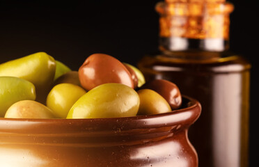 Lot of different olives in pot.