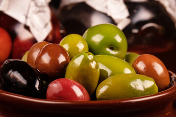 Lot of different olives in pot.
