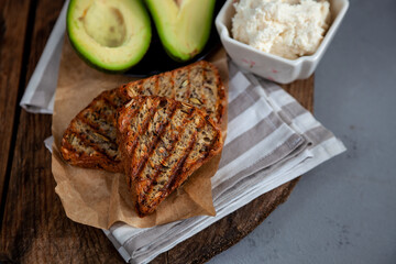 Sandwiches with soft cheese, avocado and cucumber. Breakfast is on the table. Healthy food. Toast and spread on it. Avocado sandwich stilllife. Healthy food. Toast.
