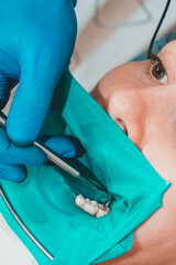 treatment of a chewing tooth, the dentist put a rubber dam, uses sterile tools, uses modern...