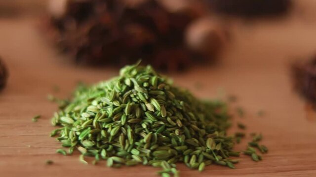 spices and herbs on kitchen or wooden table,Colorful spices and herbs for cooking with rotation teblet, Jaiphal, Star Anise, Chakri fool, Cardamom, Elaichi, Saunf,background rotating,