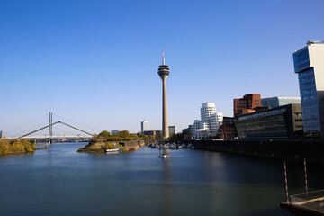 Fototapeta na wymiar Dusseldorf (Medienhafen), Germany - November 7. 2020: View over river on television tower, buildings with modern futuristic architecture design