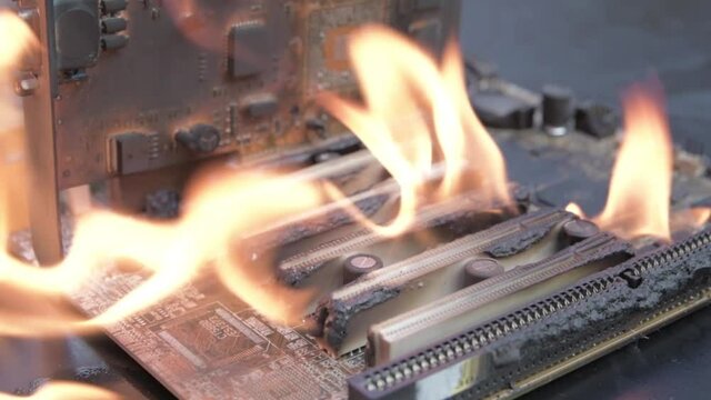 Computer motherboard ,circuit board is on fire to burn,flame. short circuit, burns computer chip