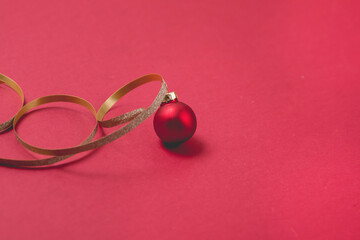 Christmas or New Year Card or Background Red Christmas Ball and Golden Thread Red Background Top View