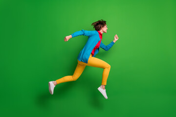 Fototapeta na wymiar Full length body size side profile photo of jumping high hurrying up running girl isolated on vivid green color background