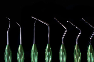 set of dental instruments close-up for surgical procedures, on a black background