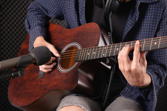 Close Up Of Man Hand Playing Acustic Guitar