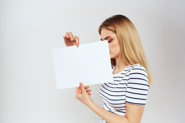 Naklejka premium woman holding a sheet of paper in her hands lifestyle striped t-shirt cropped view Copy Space