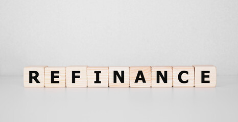 Focus on wooden blocks with text Refinance