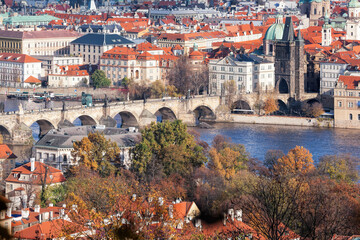 Fototapeta na wymiar Charles bridge with autumn trees in Prague, Czech Republic