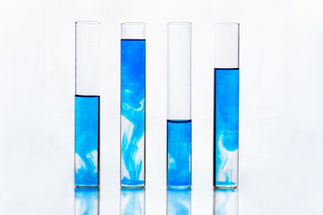 Glass test tubes or flasks with blue liquid on white background for scientific analysis. laboratory research and development concept. scientist sample chemistry or medicine test