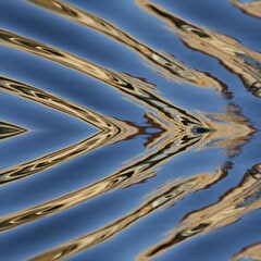abstract water reflection patterns in shades of blue silver and gold