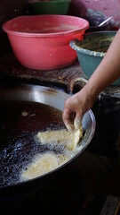 hand fry traditional food namely tempeh in a hot pan