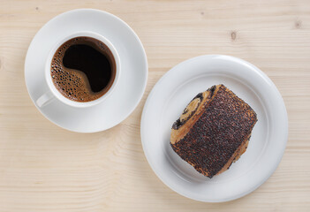 Bun with poppy seeds and coffee
