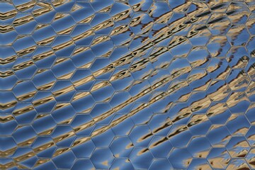 abstract water reflection hexagonal mosaic patterns in shades of blue silver and gold