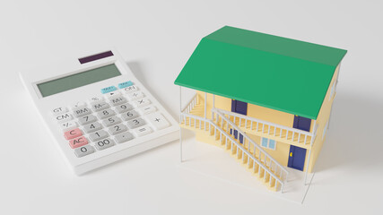 平面上に置かれたおもちゃのアパートと電卓