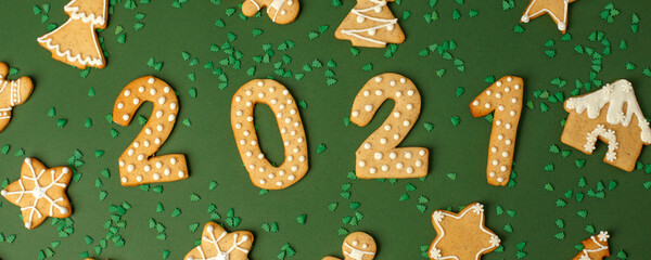 Winter Holiday banner- set of gingerbread on natural green background - Number Happy New Year 2021, house, stars and xmas tree sprinkles, Merry Christmas background, trendy concept, flyer, invitation