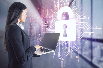 Woman working with laptop on lock symbol hologram with microcircuit background, double exposure,...