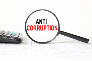 words ANTI CORRUPTION in a magnifying glass on a white background. business concept