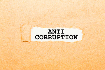 text ANTI CORRUPTION on a torn piece of paper, business concept