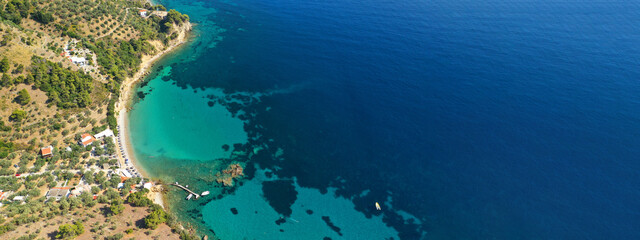 Aerial ultra wide panoramic view of tropical paradise rocky bay visited by sailboats and yachts in Caribbean exotic destination island