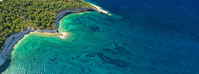 Aerial ultra wide panoramic view of tropical paradise rocky bay visited by sailboats and yachts in Caribbean exotic destination island