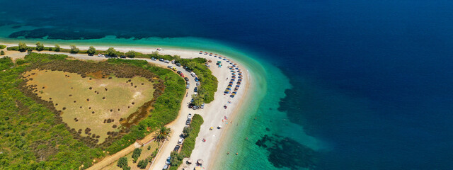 Obraz premium Aerial drone ultra wide panoramic view of tropical paradise sandy beach visited by sailboats and yachts in Caribbean exotic destination island