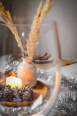 Dried flowers and a candle through glass