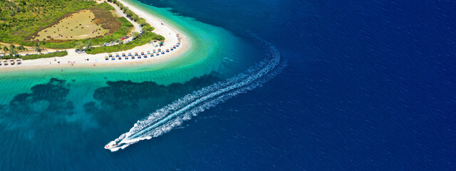 Aerial ultra wide panoramic view of tropical paradise rocky bay visited by sailboats and yachts in...