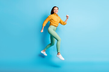 Full size profile photo of cool excited brunette lady jump wear shirt trousers sneakers isolated on teal color background