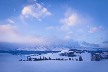 Obraz premium Winter mountain landscape. Blue sky with clouds, Trees in the snow. Winter in Russia.