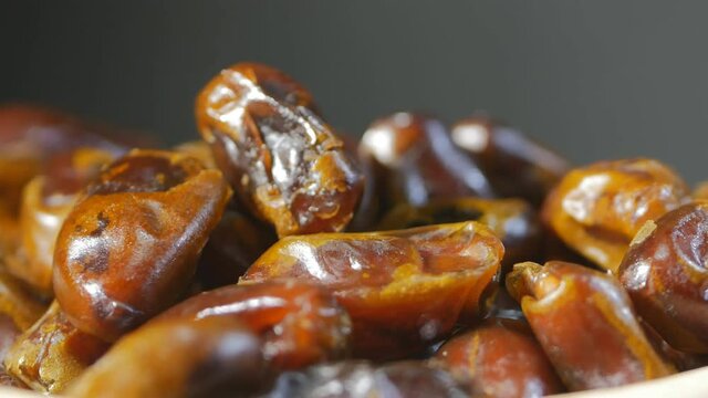 super close-up of arb dates rotating. Only dates and gray background. Healthy food concept. 4k